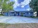 Charming single-story home with blue accents and a large driveway at 105 Old Connersville Rd, Bartow, FL 33830