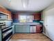 Well-equipped kitchen with modern appliances, granite countertops, two-tone cabinetry, and stylish wood-look floors at 105 Old Connersville Rd, Bartow, FL 33830
