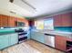 Modern kitchen with stainless steel appliances, granite countertops, two-tone cabinets, and wood-look flooring at 105 Old Connersville Rd, Bartow, FL 33830