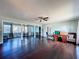 Bright living room featuring hardwood floors, a ceiling fan, and a spacious layout with natural light at 105 Old Connersville Rd, Bartow, FL 33830