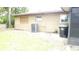 Spacious backyard with mature trees and an air conditioning unit at 112 Bishop St, Auburndale, FL 33823