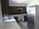 Functional kitchen featuring stainless steel refrigerator and abundant cabinet storage at 112 Bishop St, Auburndale, FL 33823