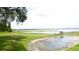 Picturesque lake view with greenery, grassy area, and serene waters at 112 Bishop St, Auburndale, FL 33823