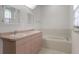 Bathroom featuring double sinks, a bathtub, and ample natural light at 1131 Country Oaks Blvd, Lake Wales, FL 33898