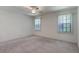 Bright bedroom with carpet, white walls, and two large windows at 1131 Country Oaks Blvd, Lake Wales, FL 33898