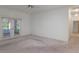 Large bedroom with white walls, plush carpeting, and glass paneled doors leading to an outdoor space at 1131 Country Oaks Blvd, Lake Wales, FL 33898