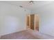 Bedroom featuring plush carpeting, white walls, standard closet and doorways to other rooms at 1131 Country Oaks Blvd, Lake Wales, FL 33898