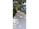Long driveway leading to a charming home with beautiful landscaping and mature trees at 1131 Country Oaks Blvd, Lake Wales, FL 33898