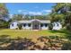 Charming single-story home with a well-manicured lawn and blue shutters at 1131 Country Oaks Blvd, Lake Wales, FL 33898