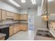 Bright kitchen boasts light wood cabinets, appliances, and neutral countertops, creating a functional cooking space at 1131 Country Oaks Blvd, Lake Wales, FL 33898