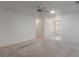 Open living room with plush carpeting, neutral walls, ceiling fan and views of the entrance at 1131 Country Oaks Blvd, Lake Wales, FL 33898
