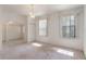 Sunlit living room with plush carpet, archways, and neutral tones at 1131 Country Oaks Blvd, Lake Wales, FL 33898