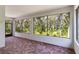 Enclosed patio area with brick flooring and large windows offering views of the lush greenery at 1131 Country Oaks Blvd, Lake Wales, FL 33898