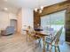Bright dining room with wood accent wall, light floors and natural light at 1205 Third Ct, Eagle Lake, FL 33839