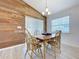 Bright dining room with wood accent wall, light floors and natural light at 1205 Third Ct, Eagle Lake, FL 33839
