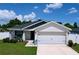 Well-maintained single-Gathering home featuring an attached two-car garage and manicured lawn at 1205 Third Ct, Eagle Lake, FL 33839