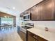 Open kitchen view flowing into the bright dining area and featuring stainless steel appliances at 1205 Third Ct, Eagle Lake, FL 33839