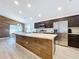Modern kitchen with stainless steel appliances and long countertops with access to the dining area at 1205 Third Ct, Eagle Lake, FL 33839