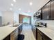 Modern kitchen with stainless steel appliances and long countertops leading to dining area at 1205 Third Ct, Eagle Lake, FL 33839