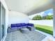 Inviting covered patio featuring a stylish purple sectional and outdoor rug at 1205 Third Ct, Eagle Lake, FL 33839