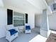 Cozy covered front porch featuring matching patio furniture and plenty of space for relaxing at 1205 Third Ct, Eagle Lake, FL 33839