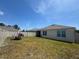The backyard features a patio set, a hanging swing, and a white vinyl fence at 1414 Fox Squirrel Dr, Davenport, FL 33897