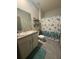 Bathroom featuring vanity with white cabinet, sink, mirror, and a shower/tub combo with decorative shower curtain at 1414 Fox Squirrel Dr, Davenport, FL 33897