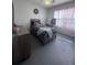This bedroom has one window, dresser, and is decorated with neutral tones at 1414 Fox Squirrel Dr, Davenport, FL 33897
