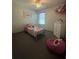Bedroom featuring single bed, and a polka-dot beanbag. Nice window for natural lighting at 1414 Fox Squirrel Dr, Davenport, FL 33897