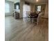 Open dining area with modern flooring, dining table and chairs and natural light at 1414 Fox Squirrel Dr, Davenport, FL 33897