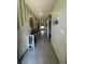 Bright hallway with decorative shelf, tiled floor, and arched doorways leading to other rooms at 1414 Fox Squirrel Dr, Davenport, FL 33897