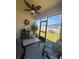 Comfortable lanai features outdoor seating, ceiling fan, and view of the backyard at 1414 Fox Squirrel Dr, Davenport, FL 33897