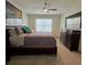 The main bedroom has a fan, a dresser, a king-size bed and an ensuite bathroom at 1414 Fox Squirrel Dr, Davenport, FL 33897