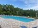 The inviting community pool is surrounded by ample lounge chairs and lush landscaping at 1414 Fox Squirrel Dr, Davenport, FL 33897