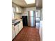 Functional kitchen featuring a stainless-steel refrigerator, ample cabinet space, and tile floors at 142 Se Ave B, Winter Haven, FL 33880