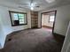 Living room showcasing carpet, built-in shelving and a glimpse into another room at 142 Se Ave B, Winter Haven, FL 33880