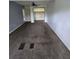 Spacious living room with neutral carpet, a ceiling fan, and doorway to another room at 142 Se Ave B, Winter Haven, FL 33880