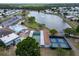 Overhead view of the lake, community pool, shuffleboard, and pickleball courts at 1575 Longbow Dr, Lakeland, FL 33810