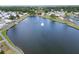 Scenic aerial view of a lake in the community with a water fountain in the center at 1575 Longbow Dr, Lakeland, FL 33810