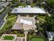 Aerial view of community clubhouse with swimming pool, tiki bar, putting green, and cornhole game at 1575 Longbow Dr, Lakeland, FL 33810