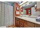 Bathroom featuring a shower with curtain, vanity, sink, mirror, and decor at 1575 Longbow Dr, Lakeland, FL 33810