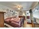Spacious bedroom with neutral walls, wood floors and a door to the bathroom at 1575 Longbow Dr, Lakeland, FL 33810