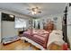 Comfortable bedroom with wood floors and a ceiling fan for added comfort at 1575 Longbow Dr, Lakeland, FL 33810