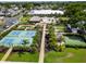 Aerial view of pickleball courts, mini golf, a putting green, and tiki huts in the community at 1575 Longbow Dr, Lakeland, FL 33810