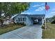Charming blue single Gathering home featuring an ample drive way and large front lawn at 1575 Longbow Dr, Lakeland, FL 33810