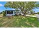 Charming single Gathering home featuring a shade tree and a well-manicured lawn at 1575 Longbow Dr, Lakeland, FL 33810