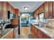 Functional kitchen with stainless steel appliances, wood cabinets, and a view into the adjacent dining area at 1575 Longbow Dr, Lakeland, FL 33810