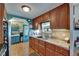 Well-maintained kitchen featuring wood cabinets, stainless steel appliances, and a connecting doorway at 1575 Longbow Dr, Lakeland, FL 33810