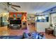 Eclectic living area with unique decorations, a large television, and an aquarium for a focal point at 1575 Longbow Dr, Lakeland, FL 33810