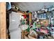 A cluttered shed with a stacked washer and dryer unit and storage at 1575 Longbow Dr, Lakeland, FL 33810